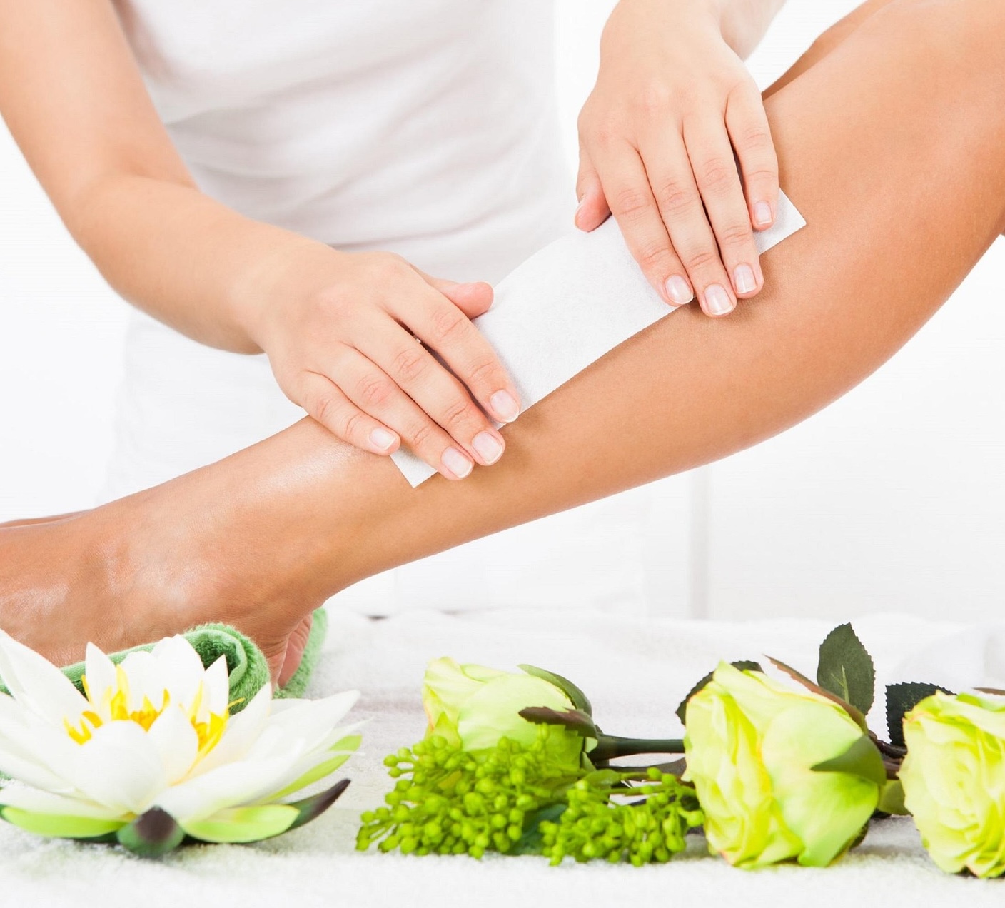 Lady waxing a persons leg