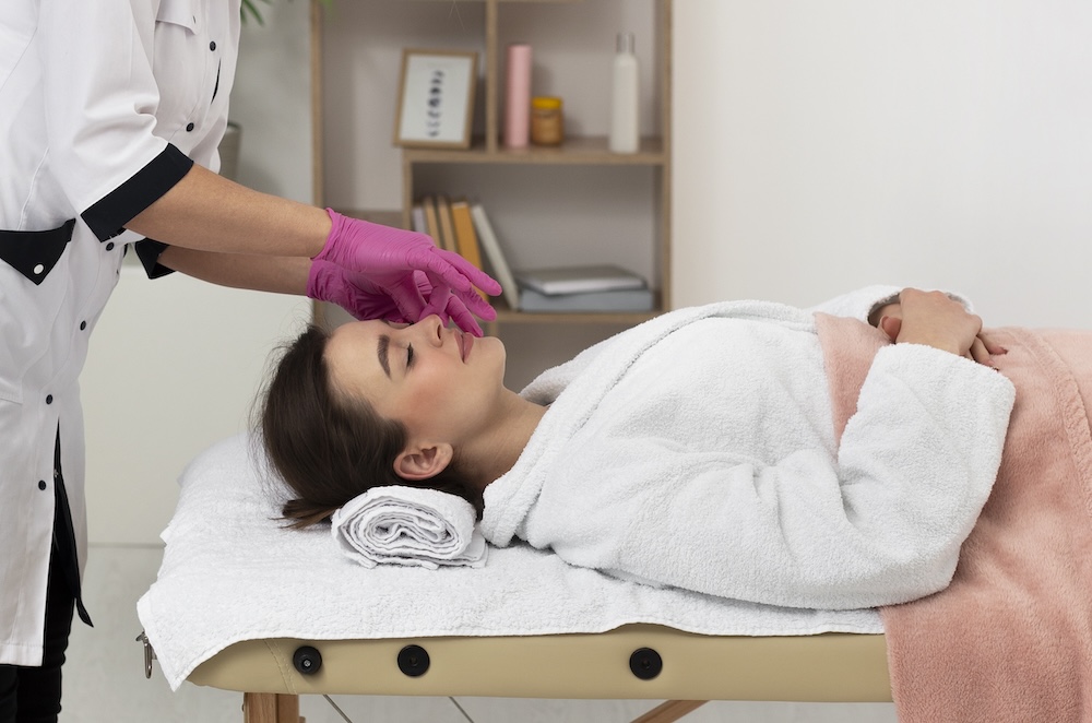 Image of a woman laying on a beauty bed